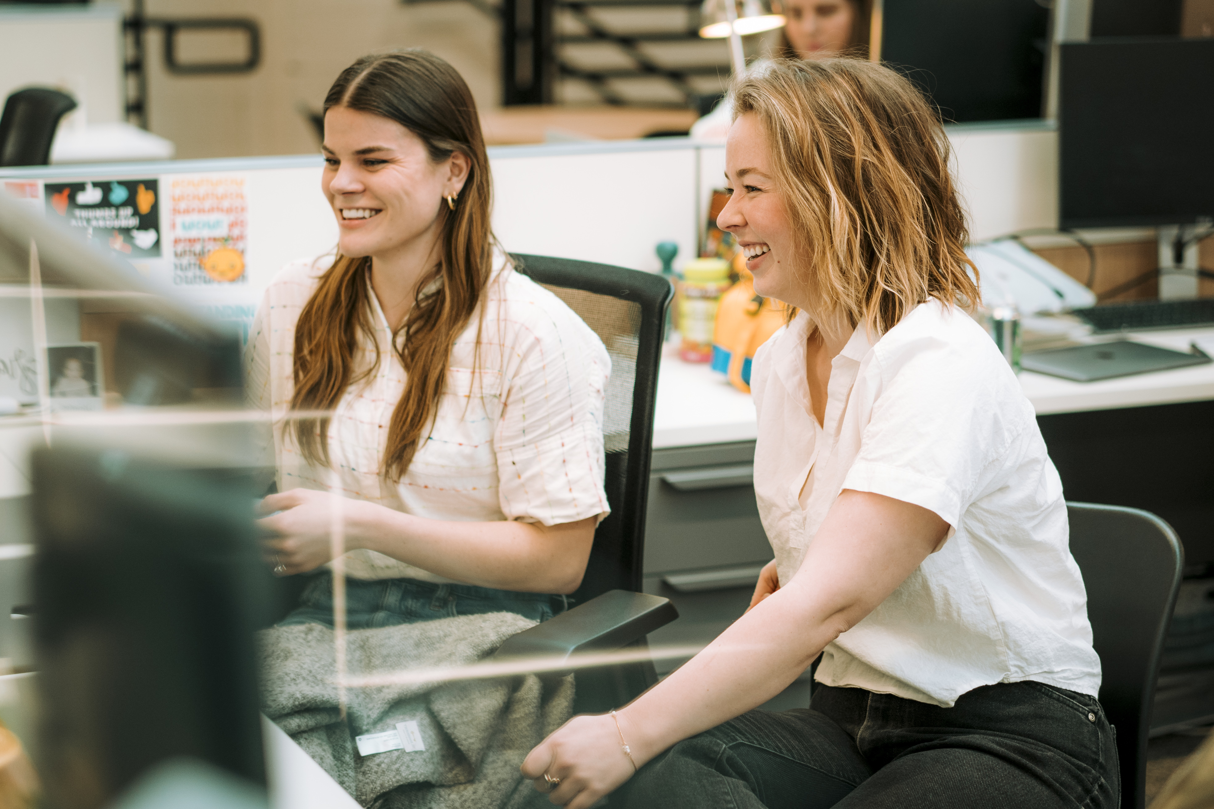 Maddie and Emily from Lemonly talking and smiling together