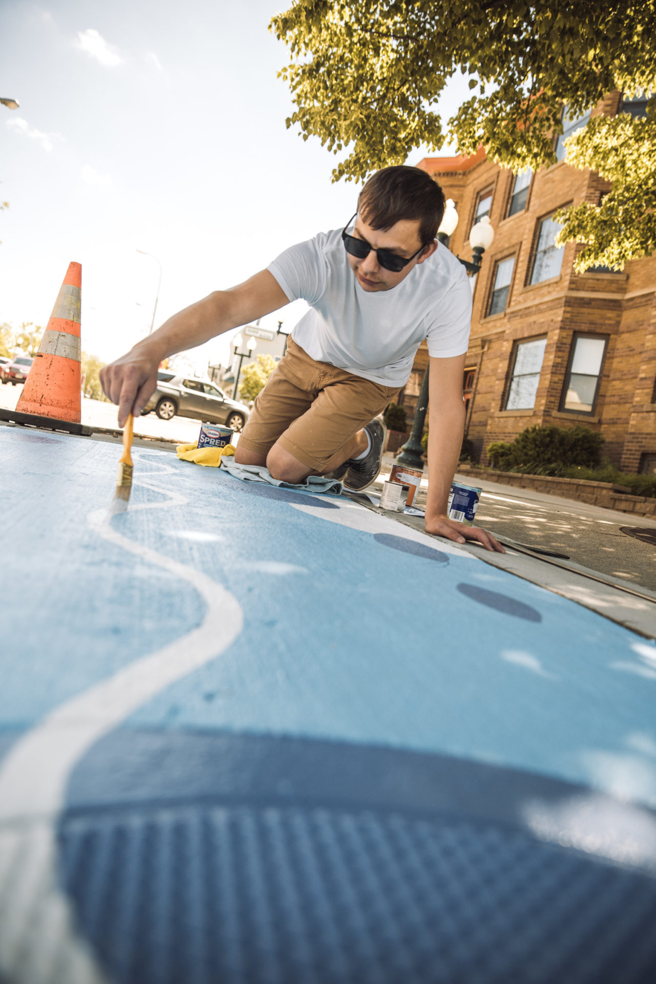 Brett painting next to a traffic cone