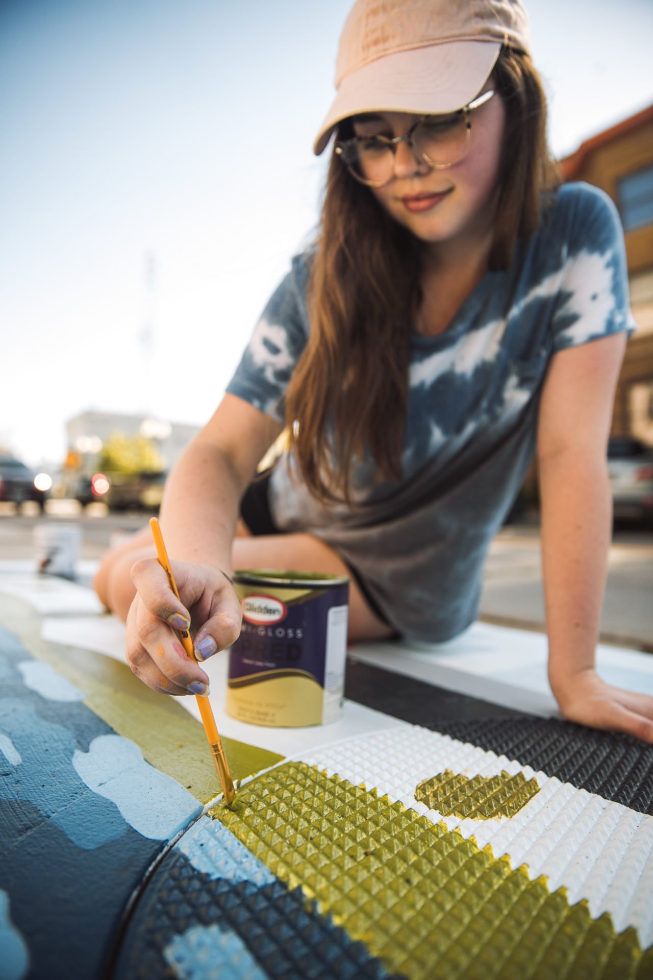 Carly painting with green paint