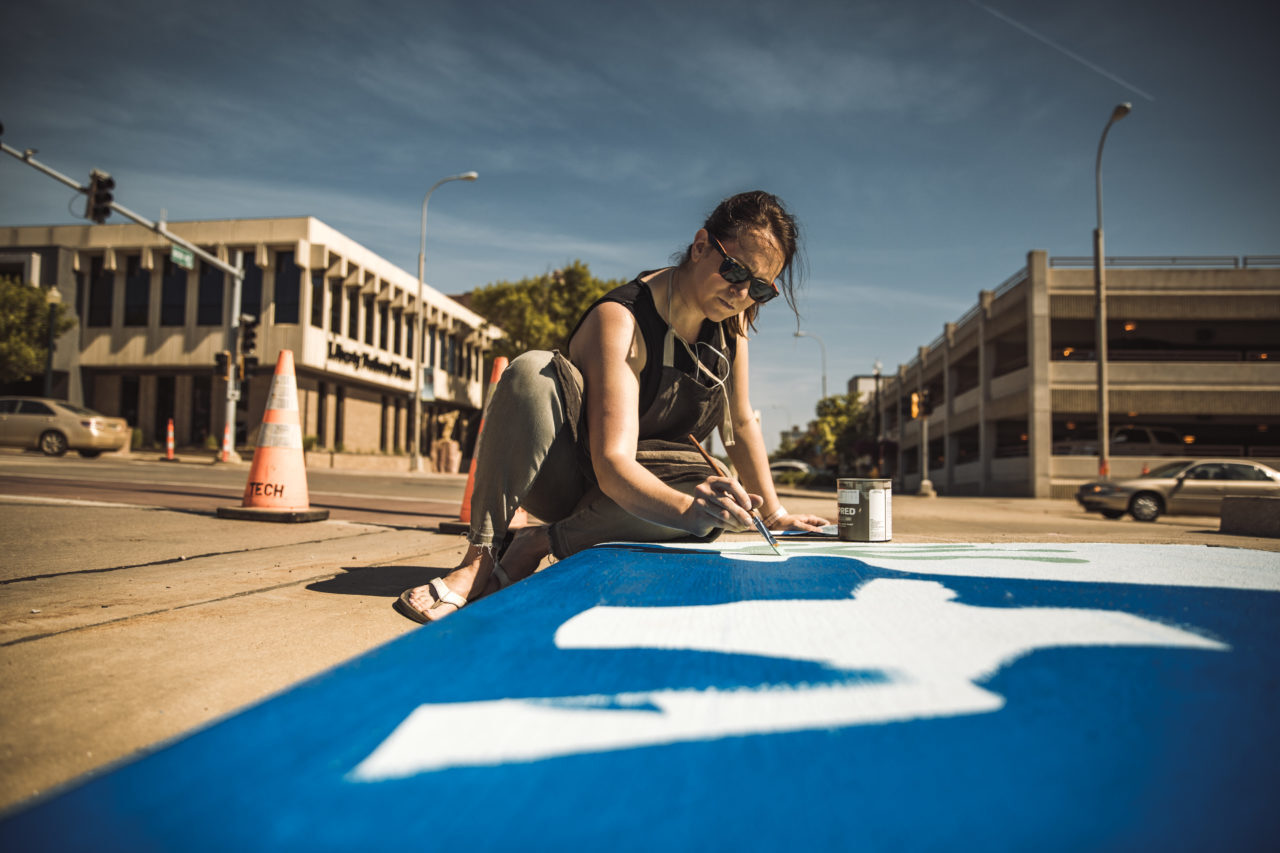 Ashton painting the ground with blue paint
