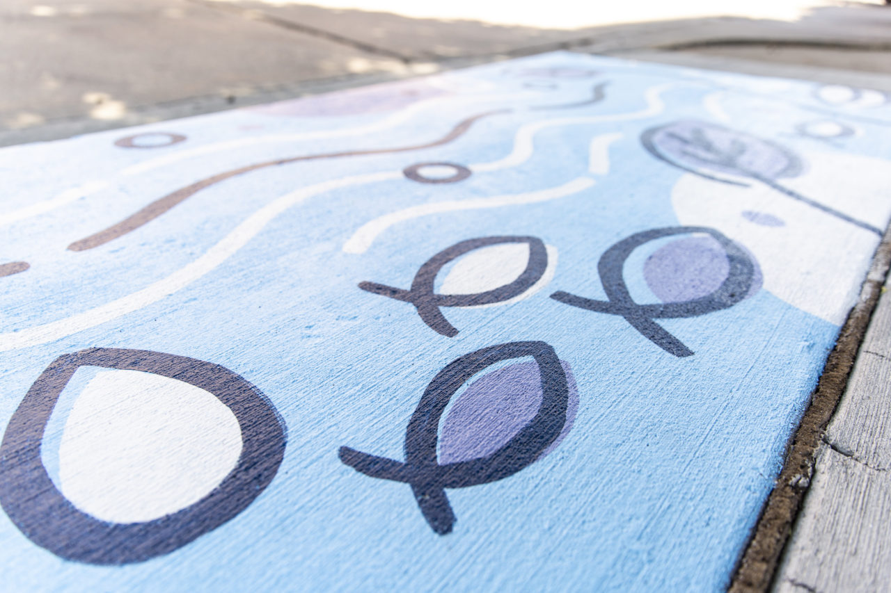 painting of fish in a stream