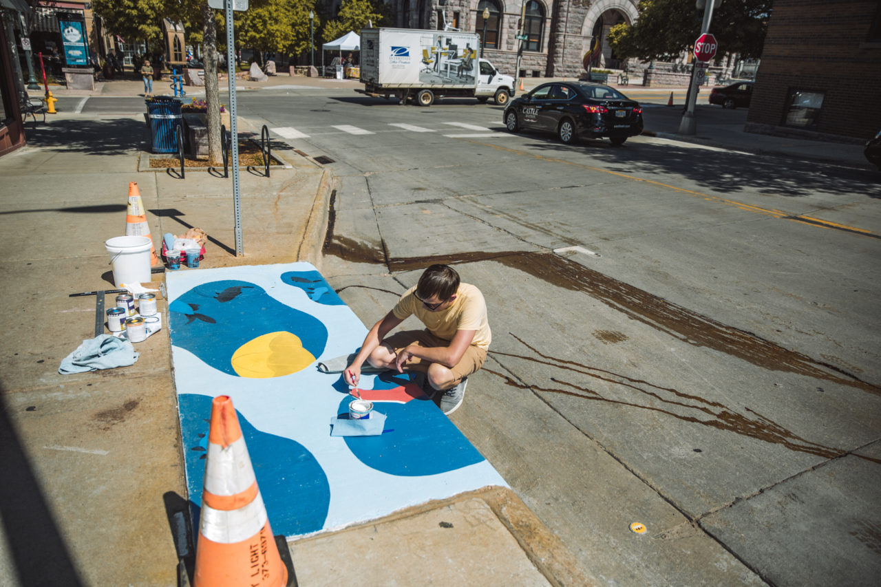 Lan painting a puddle