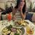 Cortney smiling with a plate of delicious food