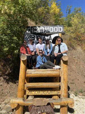Lemonly team sitting in giant wooden chair together
