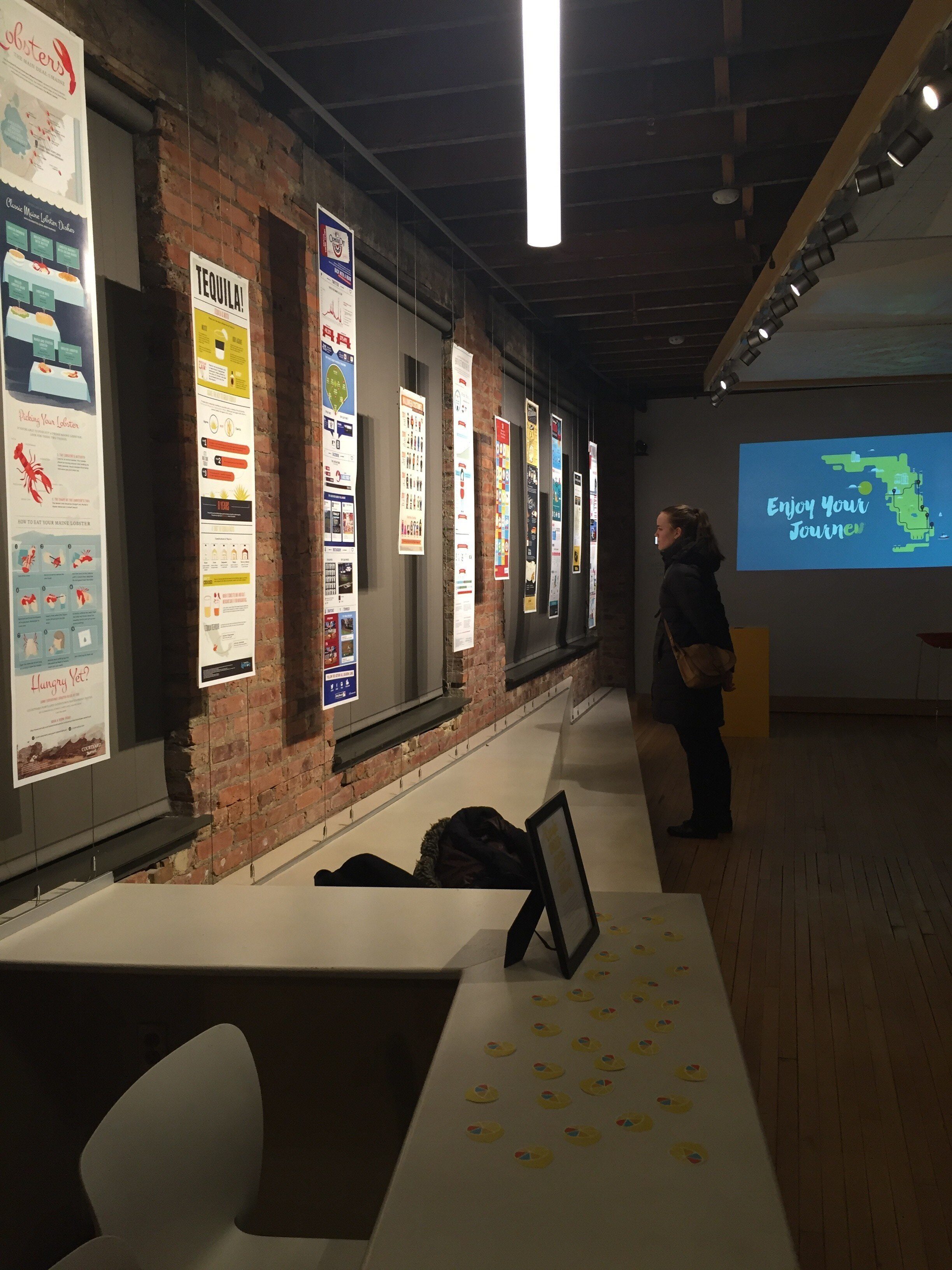 woman viewing gallery in dim lighting