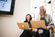 employees sitting together smiling and working with laptops